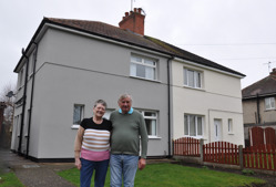 A couple outside of their home in Rhodesia which has received energy efficiency improvements