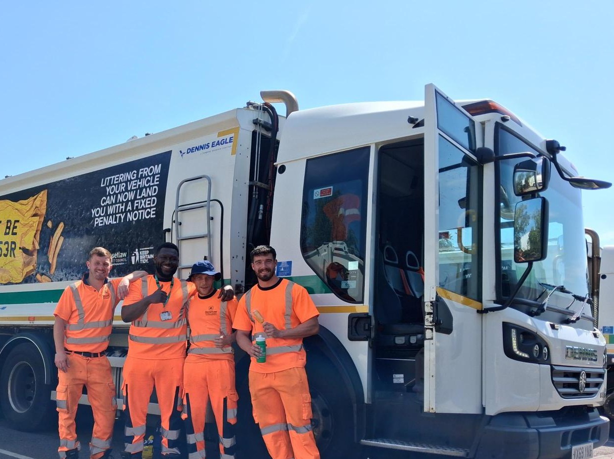 Bassetlaw District Council bin crew standing behind refuse collection vehicle.