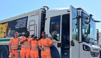 Bassetlaw District Council bin crew standing behind refuse collection vehicle.
